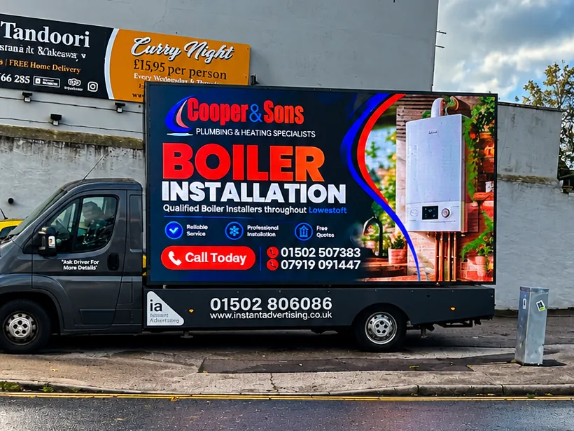 The digivan showing a Cooper and Sons advert for boiler installation, plumbing and heating