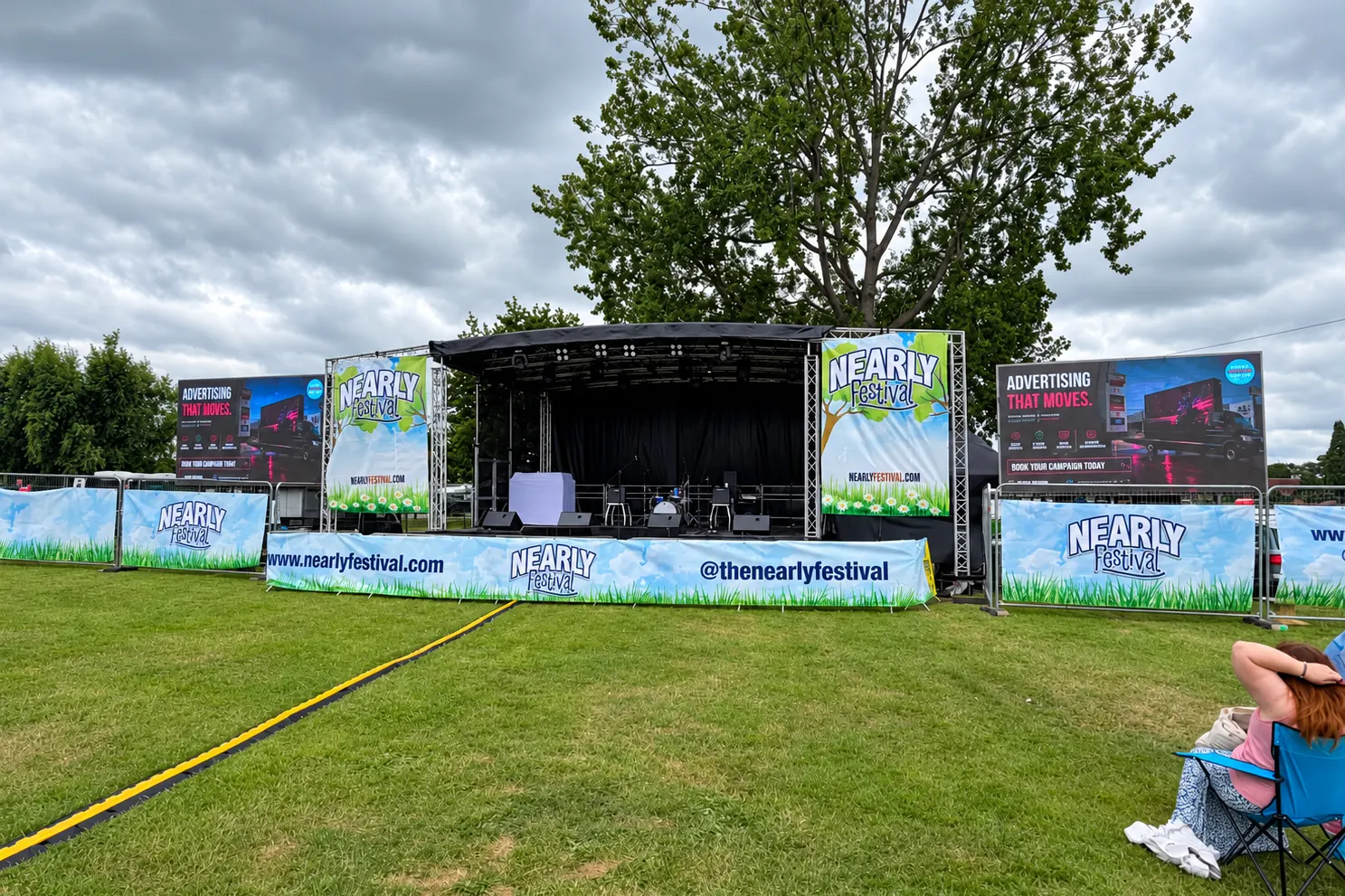 The stage at the Nearly Festival, with Instant Advertising’s own advert displayed either side of it