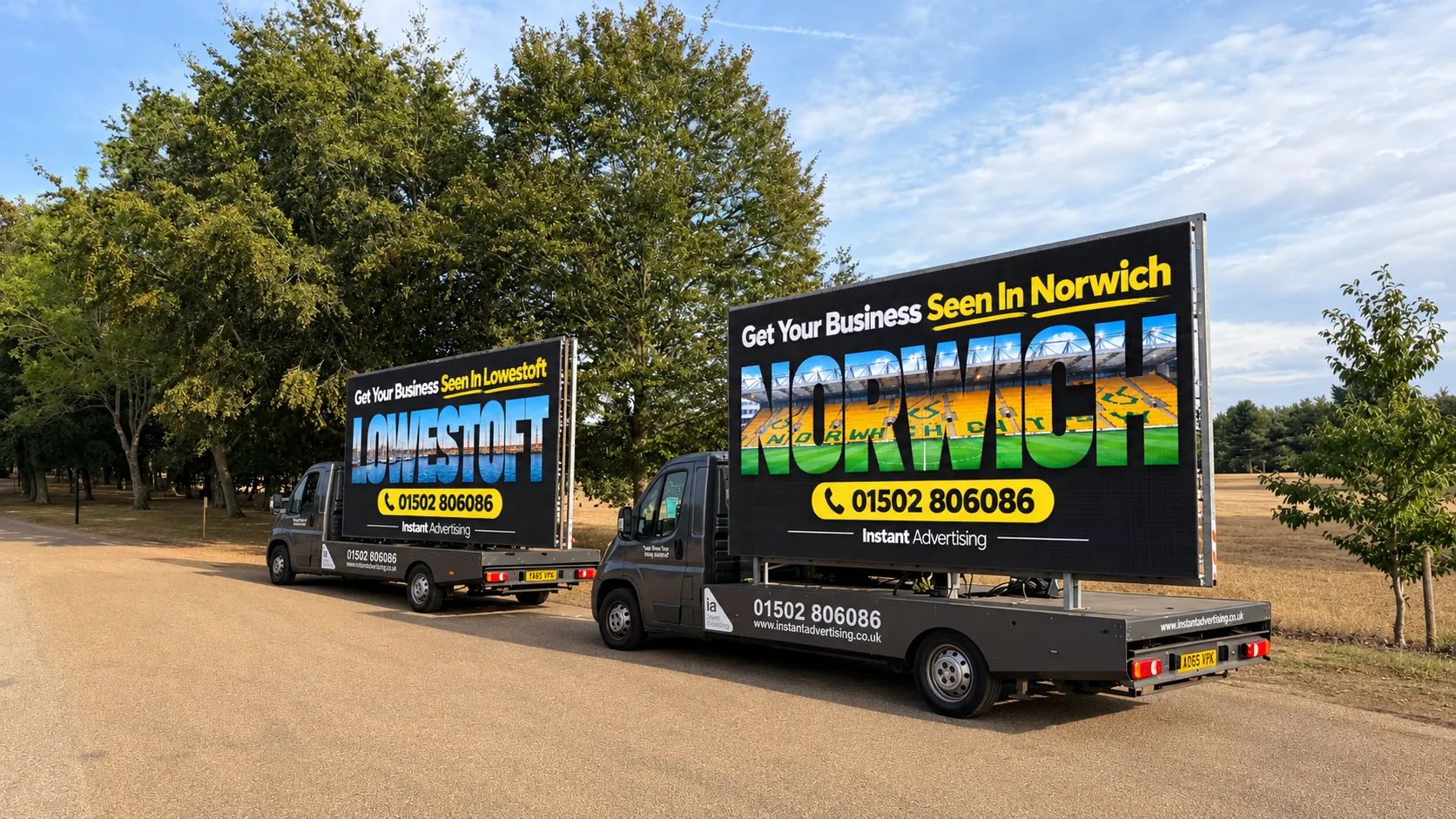Two Instant Advertising digivans parked side by side, their screens showing Get Your Business Seen in Lowestoft and Get Your Business Seen in Norwich adverts