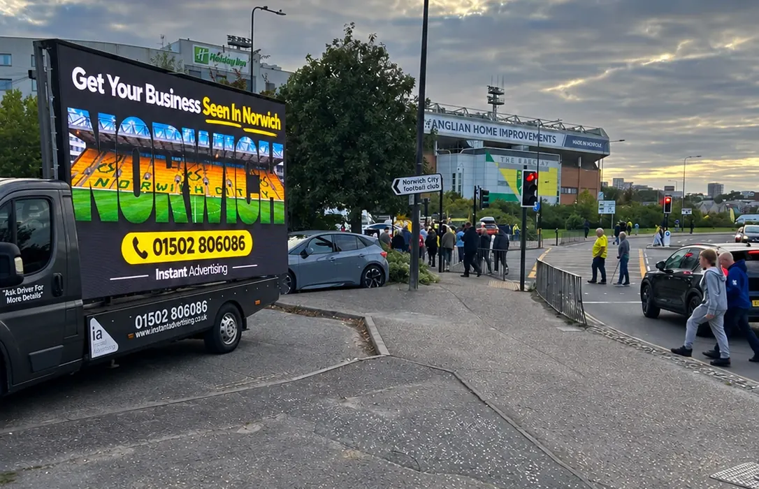 The Instant Advertising digivan near Carrow Road in Norwich, its screen reading Get Your Business Seen In Norwich